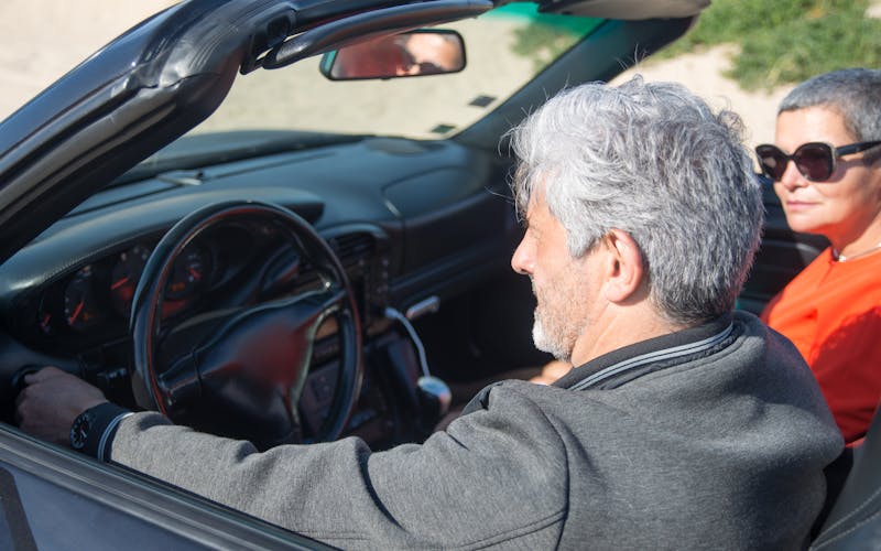 Senior couple reviewing car insurance options